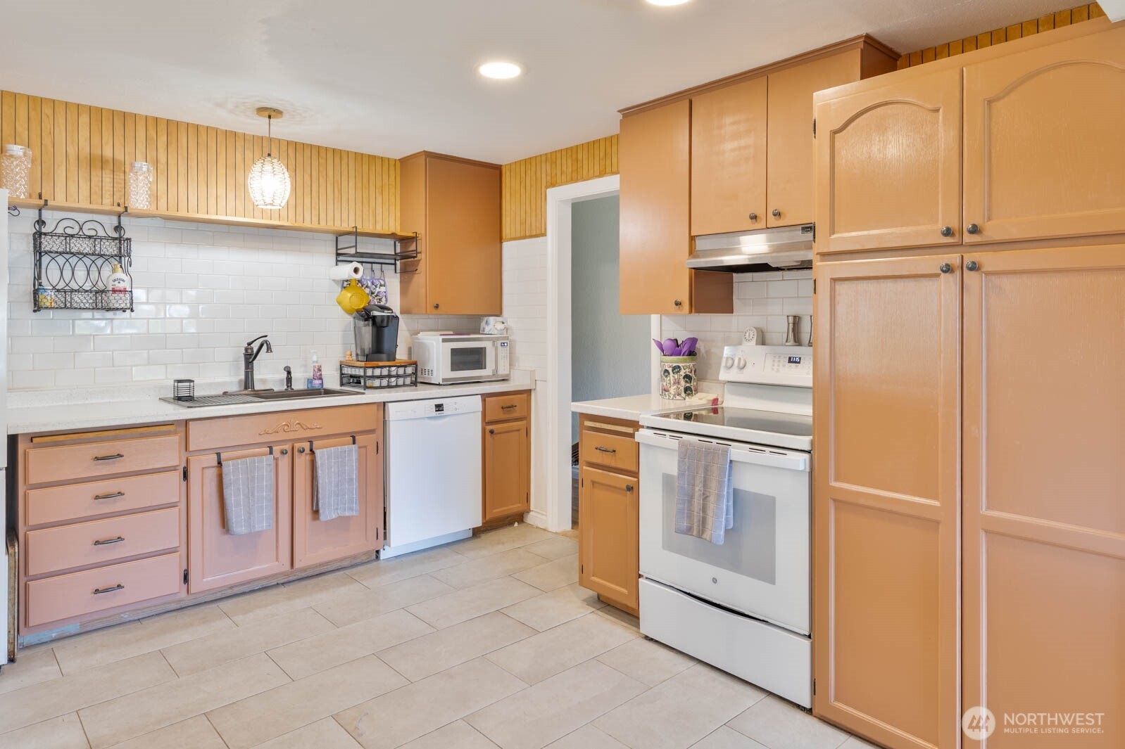 6028 South Prospect Street Tacoma, WA 98409 - Photo 8 of 32 a kitchen with white cabinets and white appliances