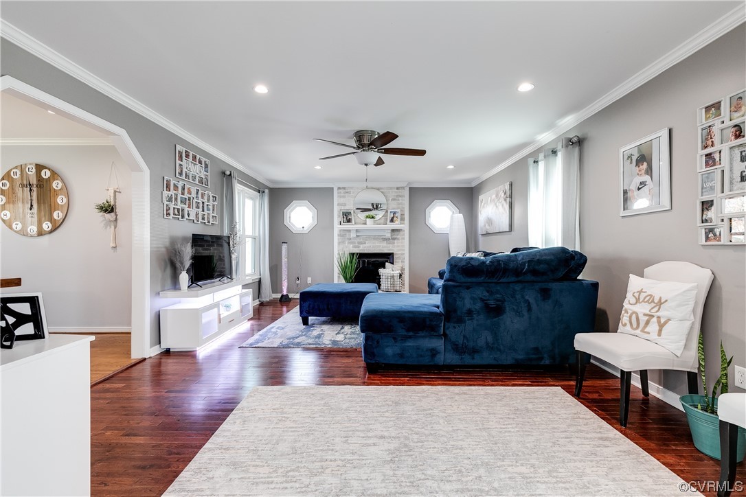 10811 Crofton Road Chester, VA 23831 - Photo 15 of 50 a living room with furniture a flat screen tv and a fireplace