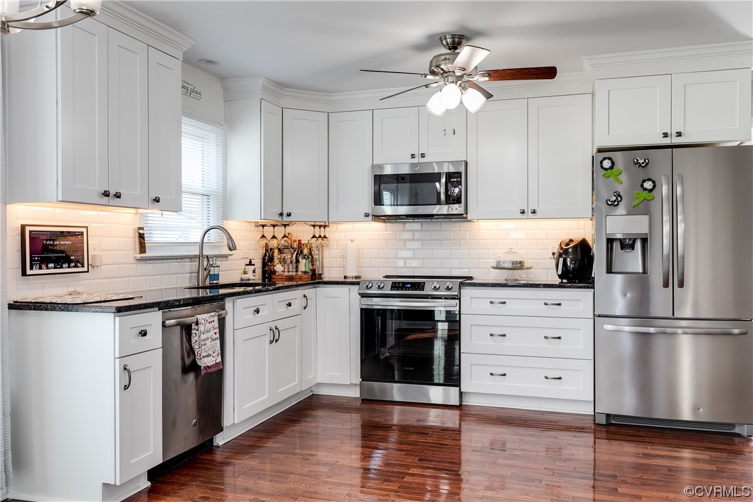 10811 Crofton Road Chester, VA 23831 - Photo 24 of 50 a kitchen with granite countertop a refrigerator stove and white cabinets