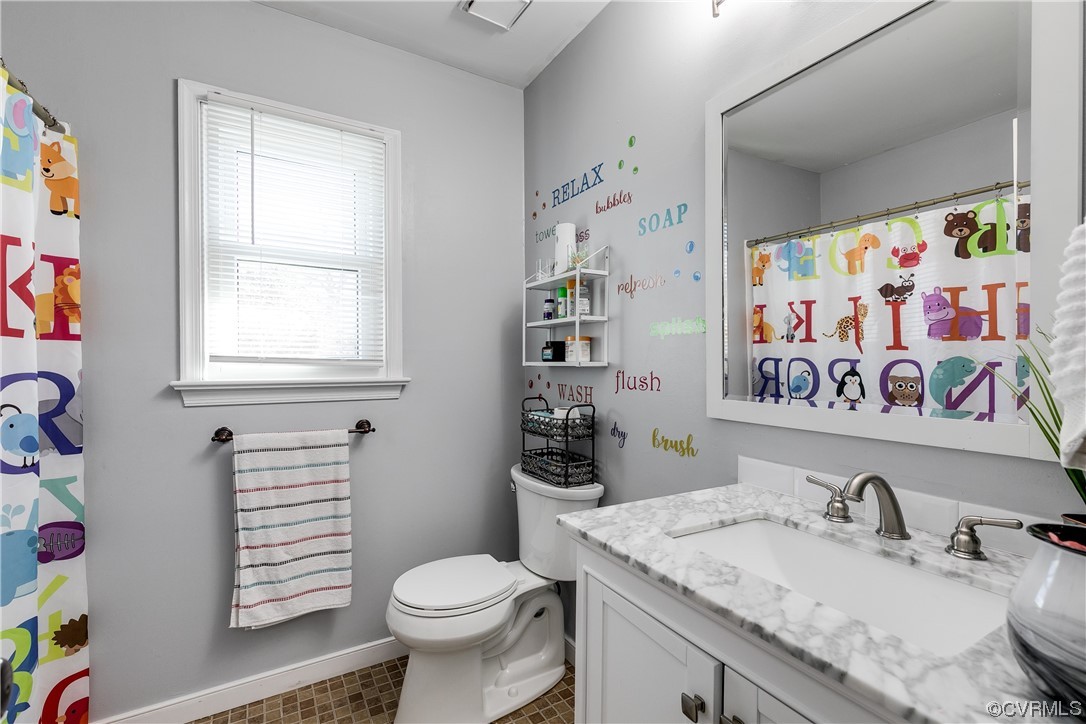 10811 Crofton Road Chester, VA 23831 - Photo 30 of 50 a bathroom with a sink a toilet and a window