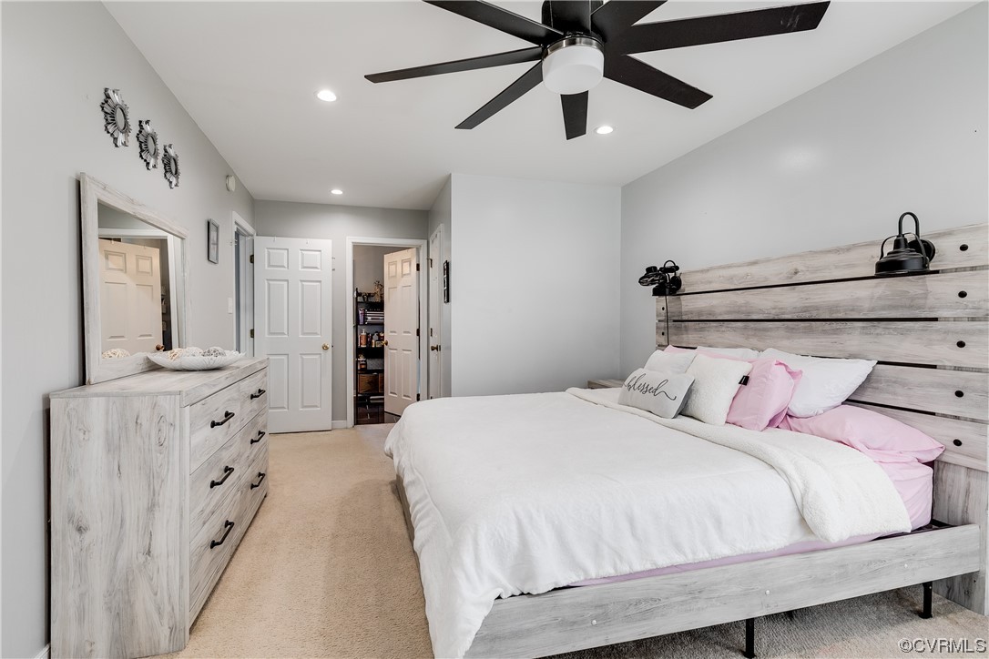 10811 Crofton Road Chester, VA 23831 - Photo 33 of 50 a large bedroom with a bed and a chandelier