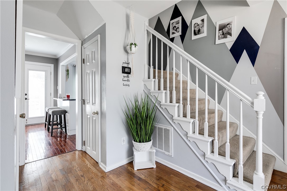 10811 Crofton Road Chester, VA 23831 - Photo 10 of 50 a view of a hallway with wooden floor and stairs