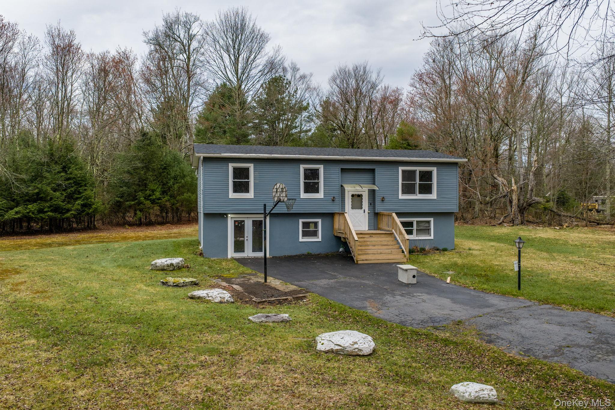 39 Dingle Daisy Road Monticello, NY 12701 - Photo 1 of 36 a view of a house with backyard porch and sitting area
