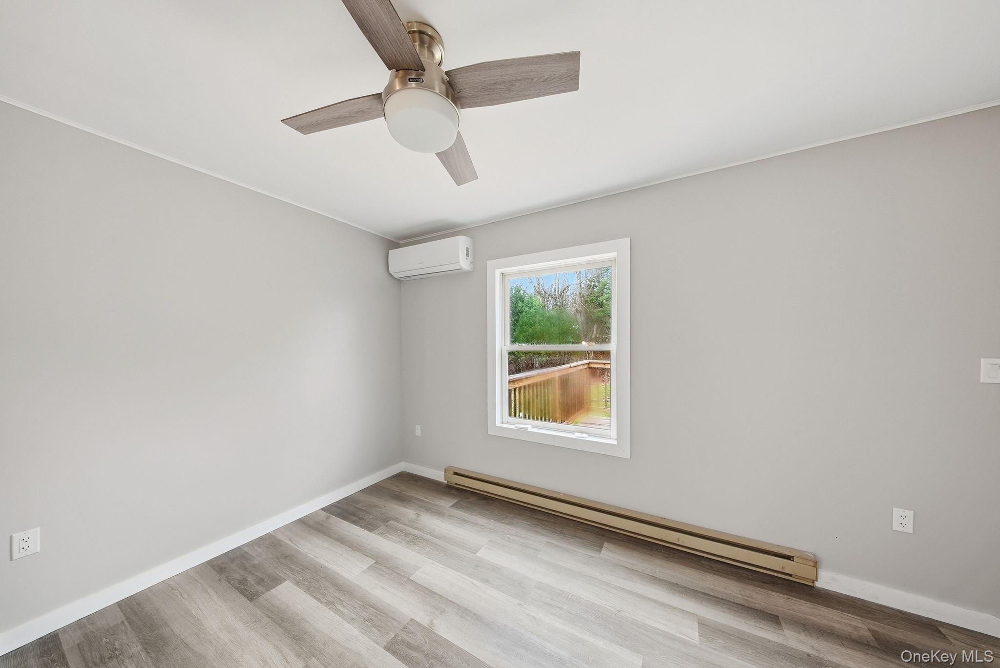 39 Dingle Daisy Road Monticello, NY 12701 - Photo 13 of 36 an empty room with a window and ceiling fan