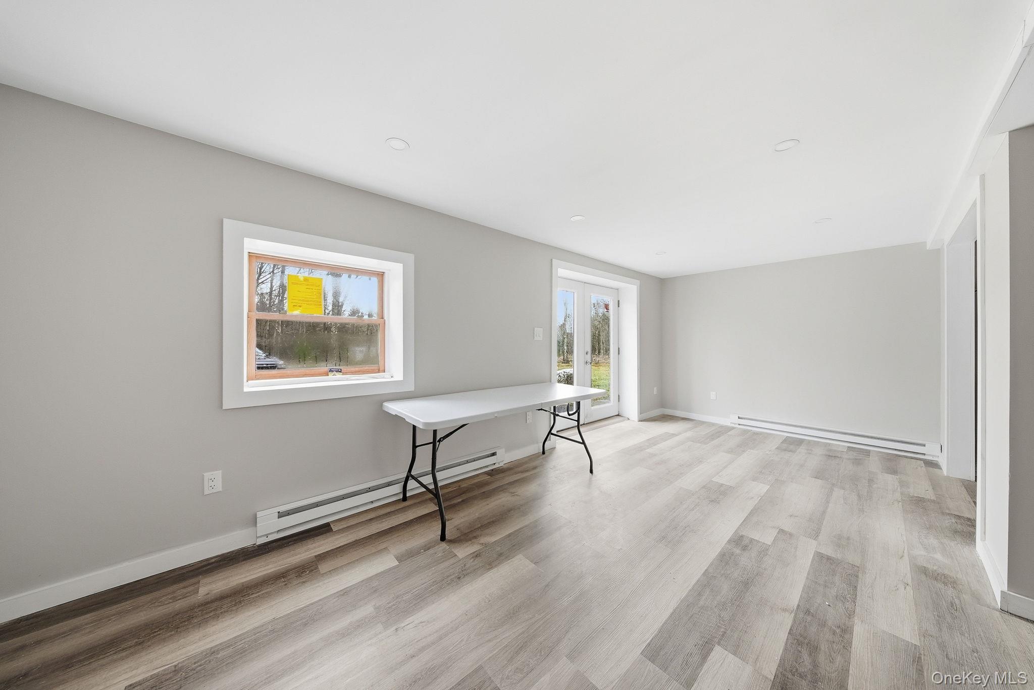 39 Dingle Daisy Road Monticello, NY 12701 - Photo 25 of 36 a view of a livingroom with wooden floor and a window