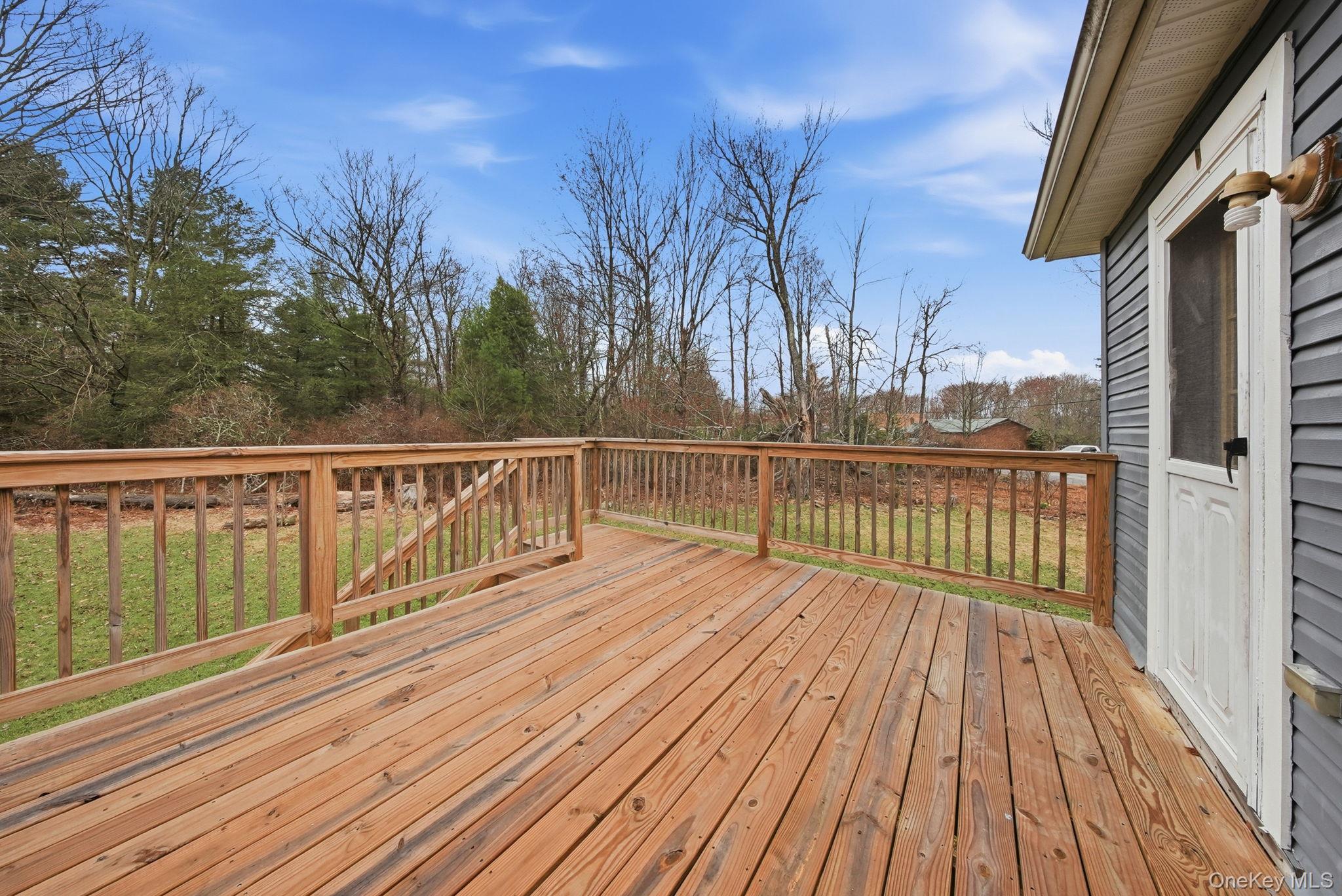 39 Dingle Daisy Road Monticello, NY 12701 - Photo 31 of 36 a view of balcony with wooden floor and fence