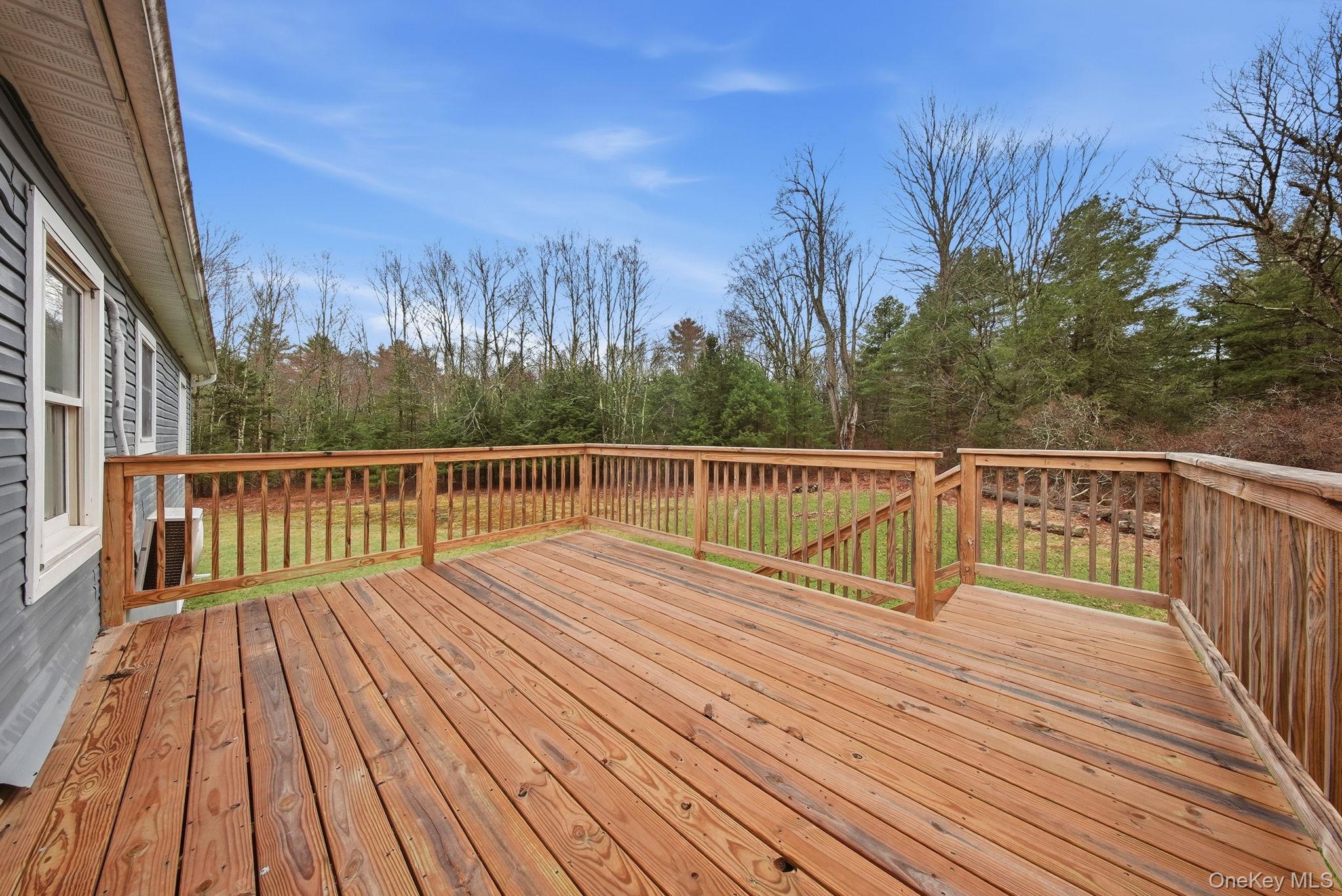 39 Dingle Daisy Road Monticello, NY 12701 - Photo 32 of 36 a view of balcony with wooden floor and fence