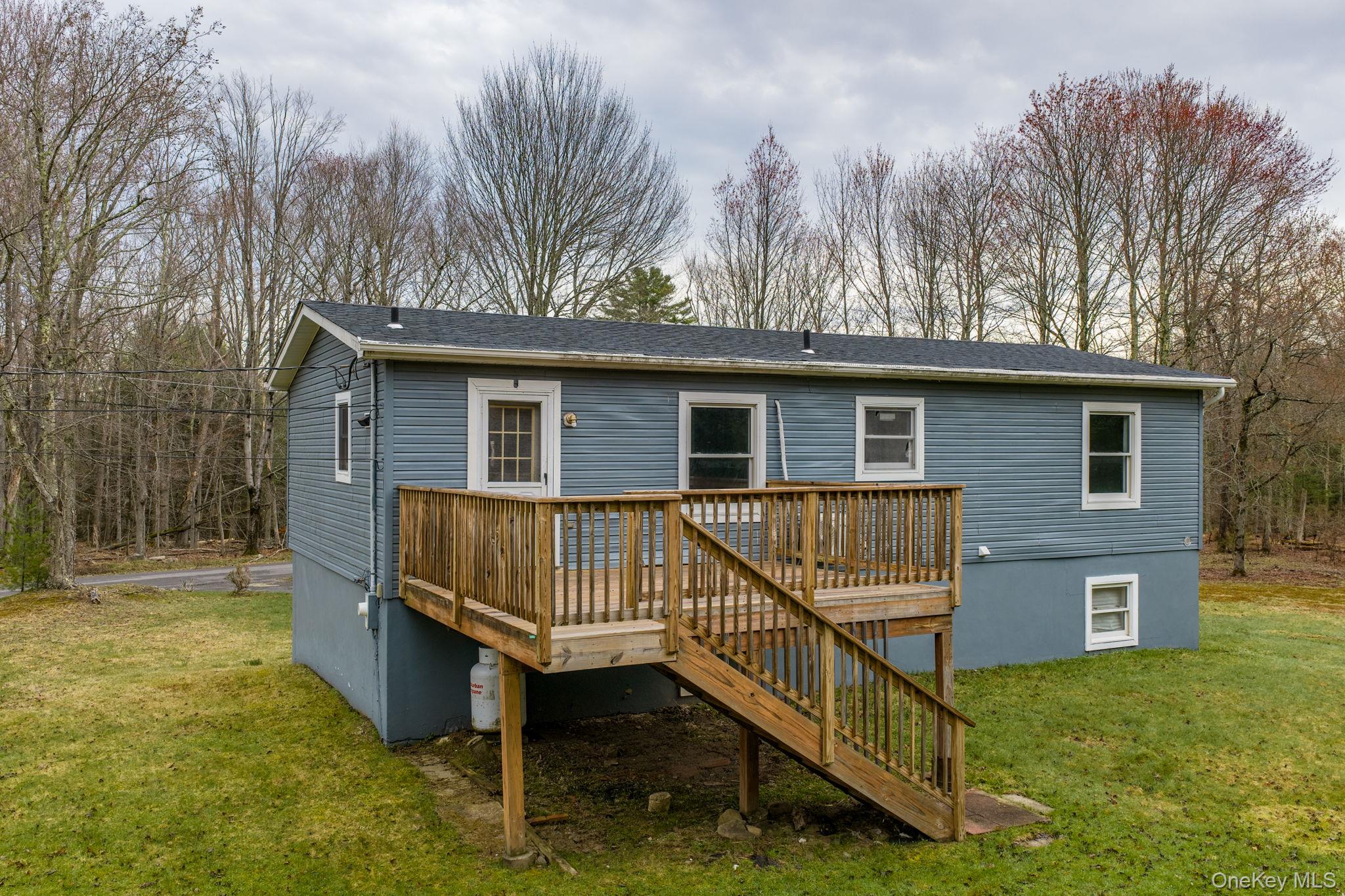 39 Dingle Daisy Road Monticello, NY 12701 - Photo 36 of 36 a view of a house with a wooden deck