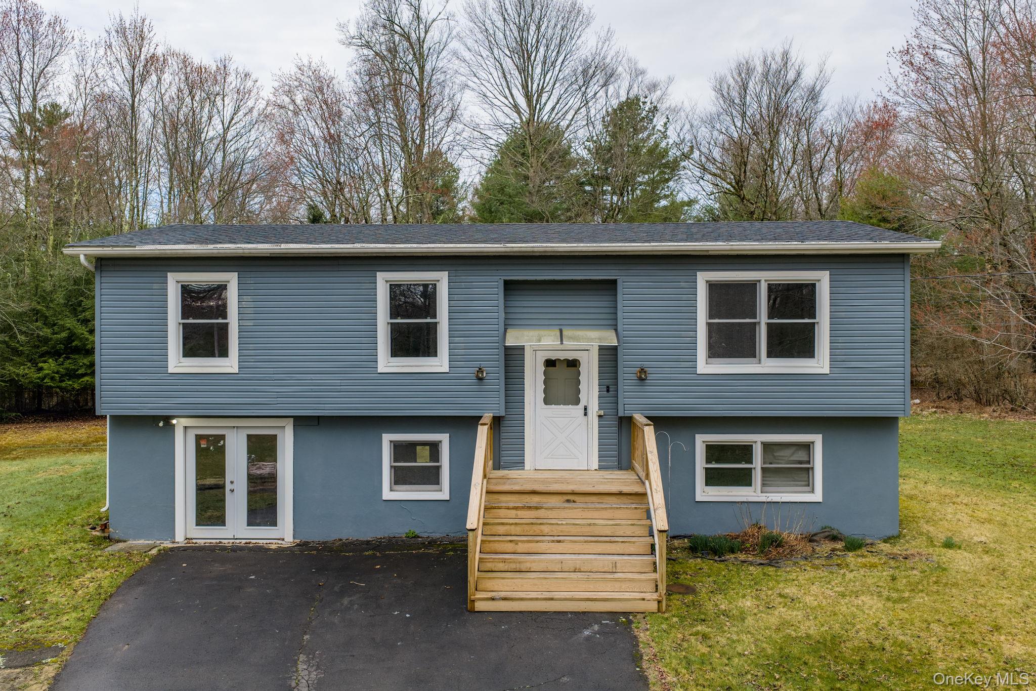 39 Dingle Daisy Road Monticello, NY 12701 - Photo 4 of 36 a front view of a house with a garden