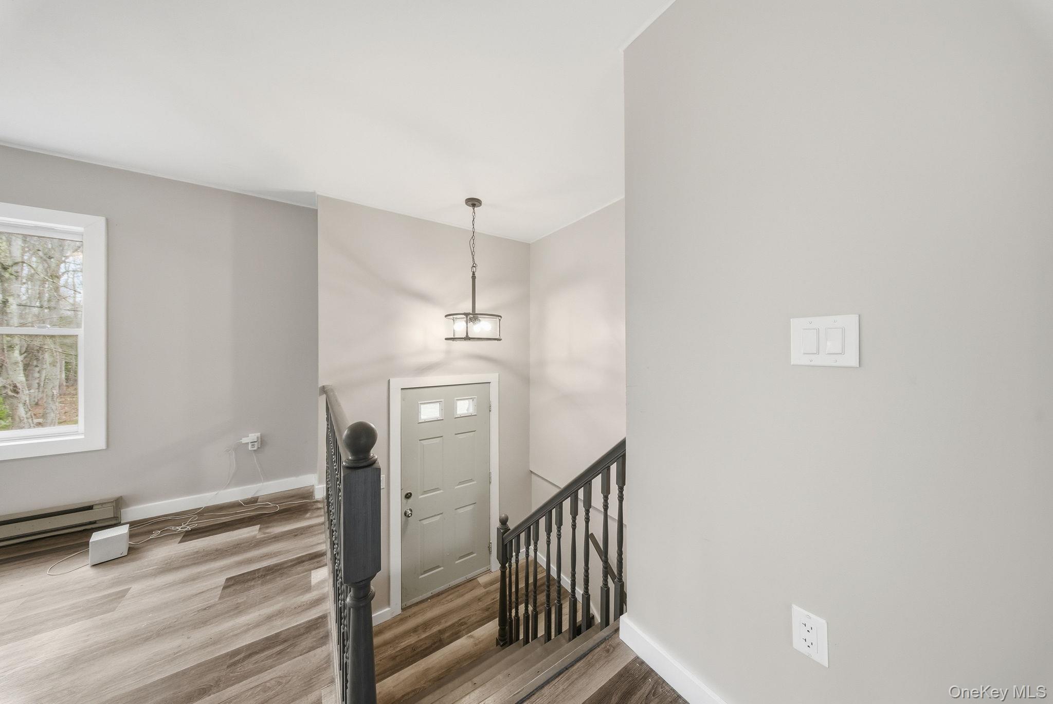 39 Dingle Daisy Road Monticello, NY 12701 - Photo 5 of 36 a view of a hallway with windows