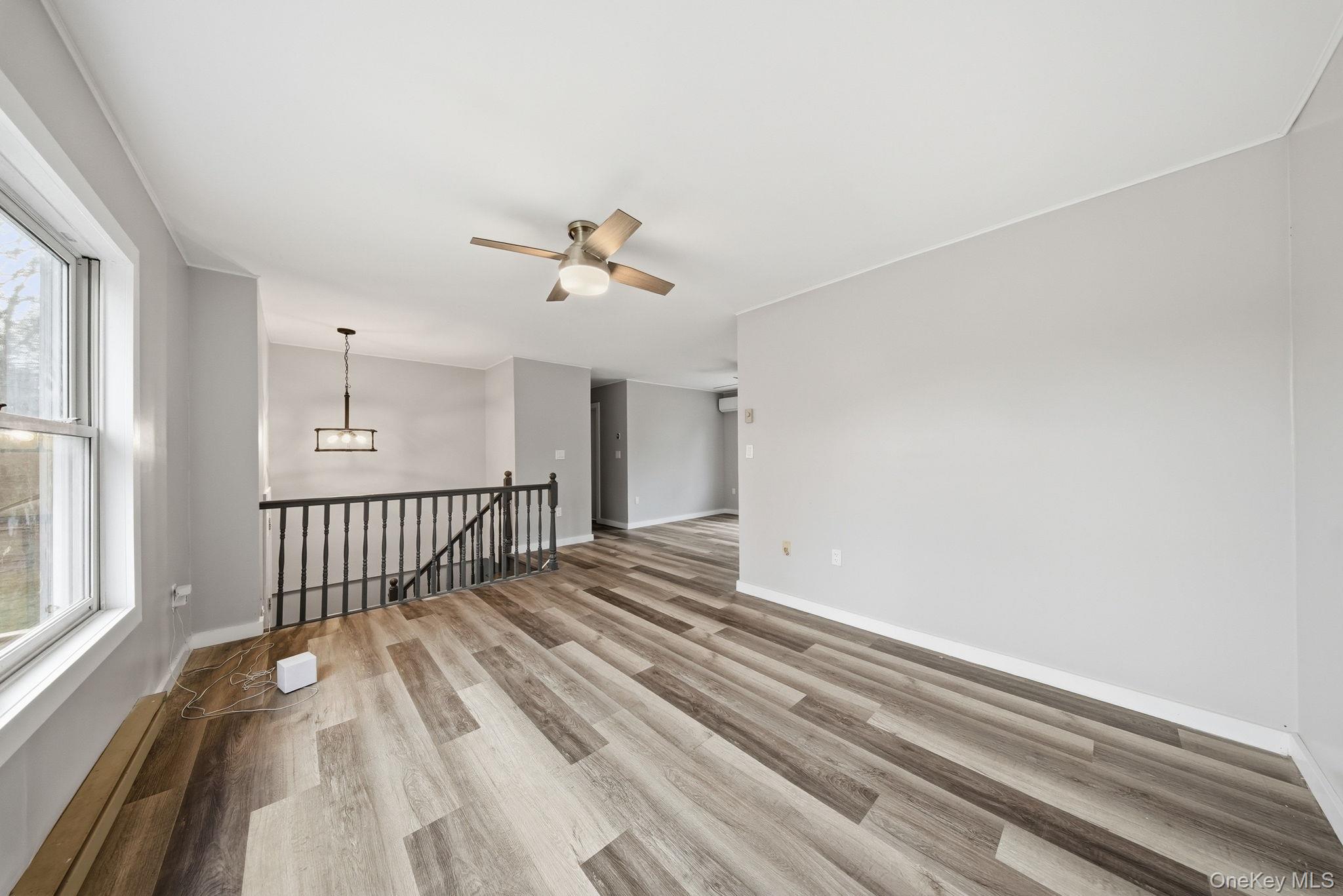 39 Dingle Daisy Road Monticello, NY 12701 - Photo 7 of 36 a view of a room with wooden floor and windows
