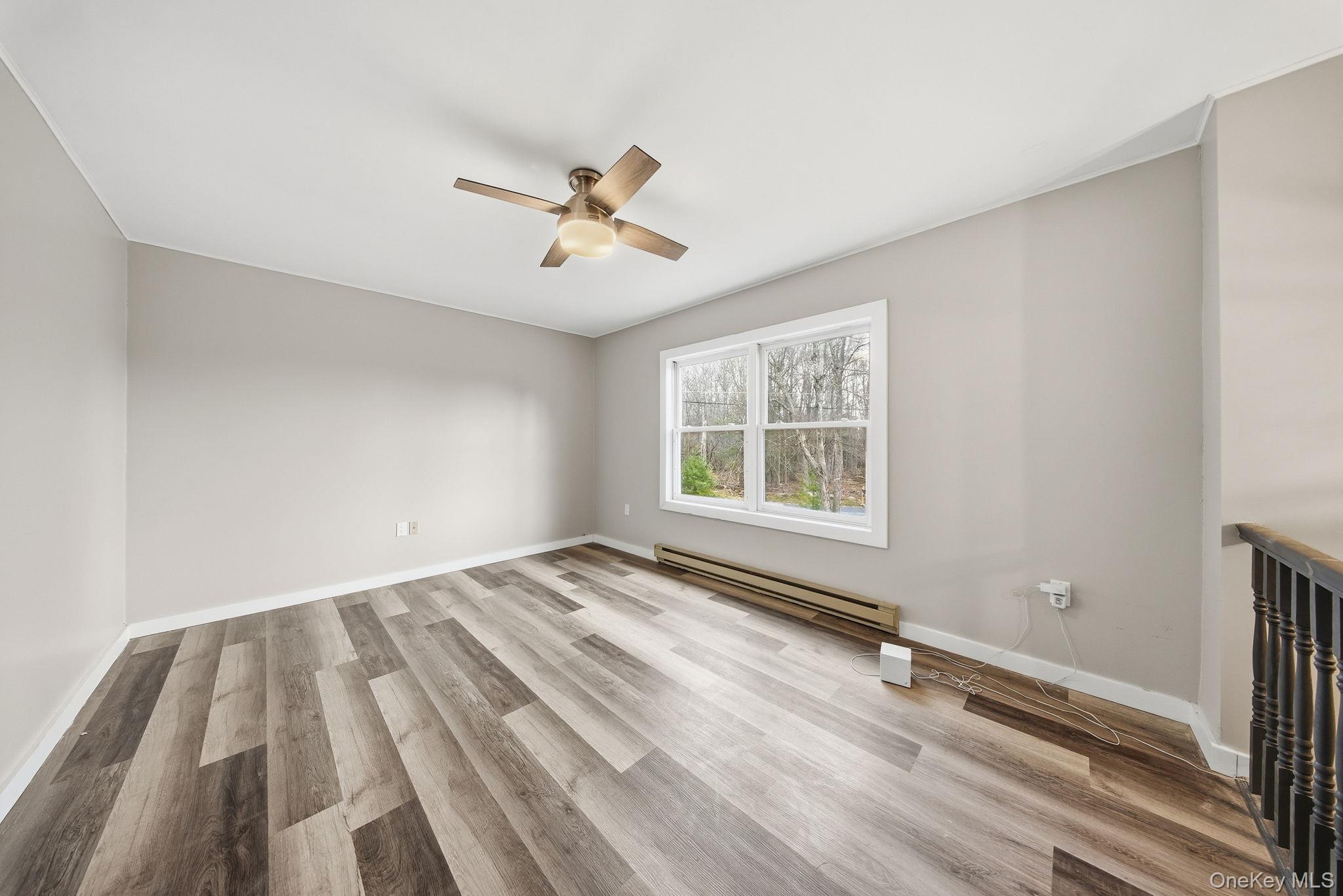 39 Dingle Daisy Road Monticello, NY 12701 - Photo 8 of 36 a view of empty room with wooden floor and fan