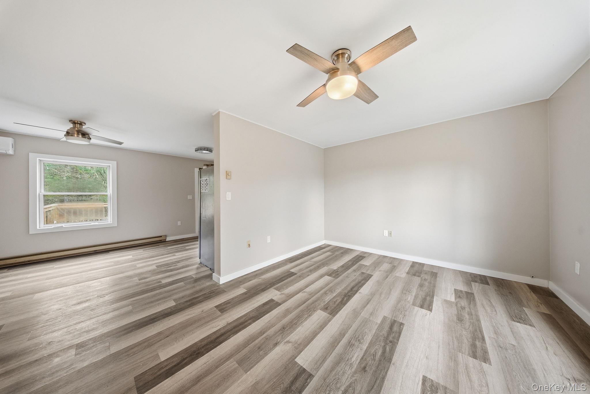 39 Dingle Daisy Road Monticello, NY 12701 - Photo 9 of 36 a view of empty room with wooden floor and fan