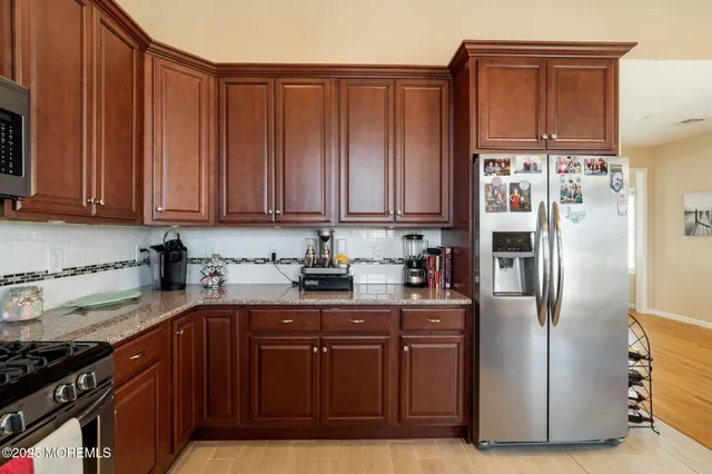 a view of a a dining room with furniture window and wooden floor