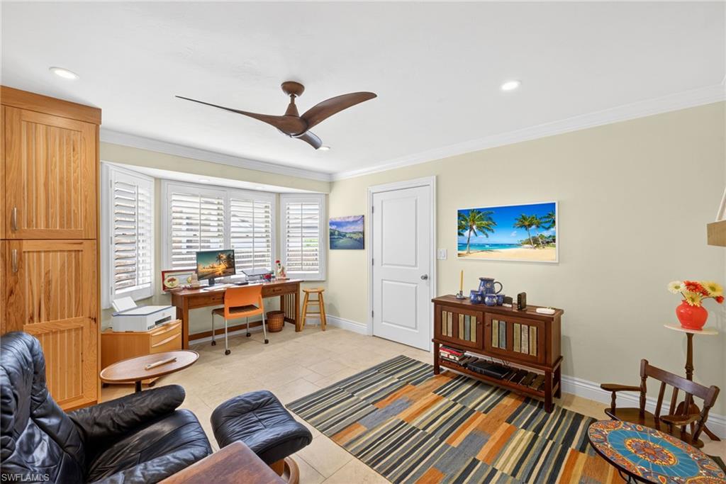 4030 Crayton Road, Unit C2 Naples, FL 34103 - Photo 13 of 32 a living room with furniture and a floor to ceiling window