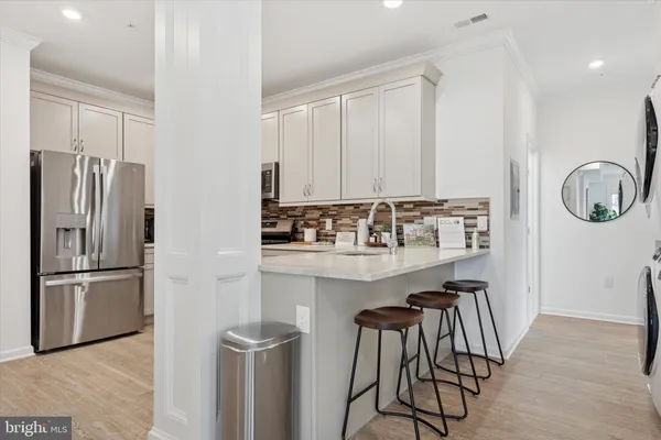 a kitchen with cabinets stainless steel appliances and a counter space
