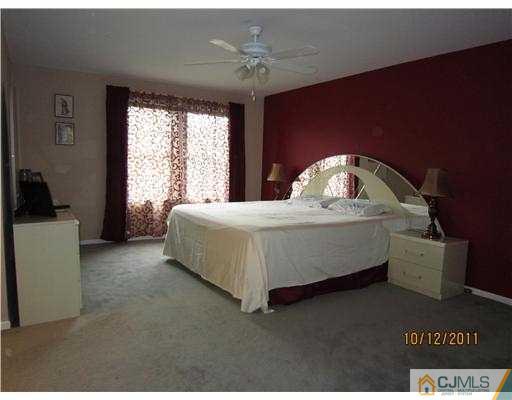 3903 Springbrook Drive Edison, NJ 08820 - Photo 6 of 11 a bed sitting in a spacious bedroom next to a window
