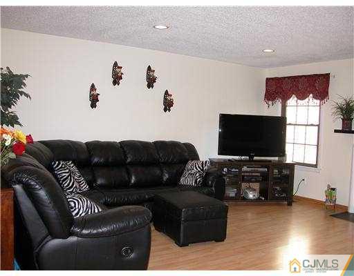 3903 Springbrook Drive Edison, NJ 08820 - Photo 7 of 11 a living room with furniture and a flat screen tv