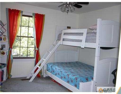 3903 Springbrook Drive Edison, NJ 08820 - Photo 10 of 11 a bedroom with a bed and a window
