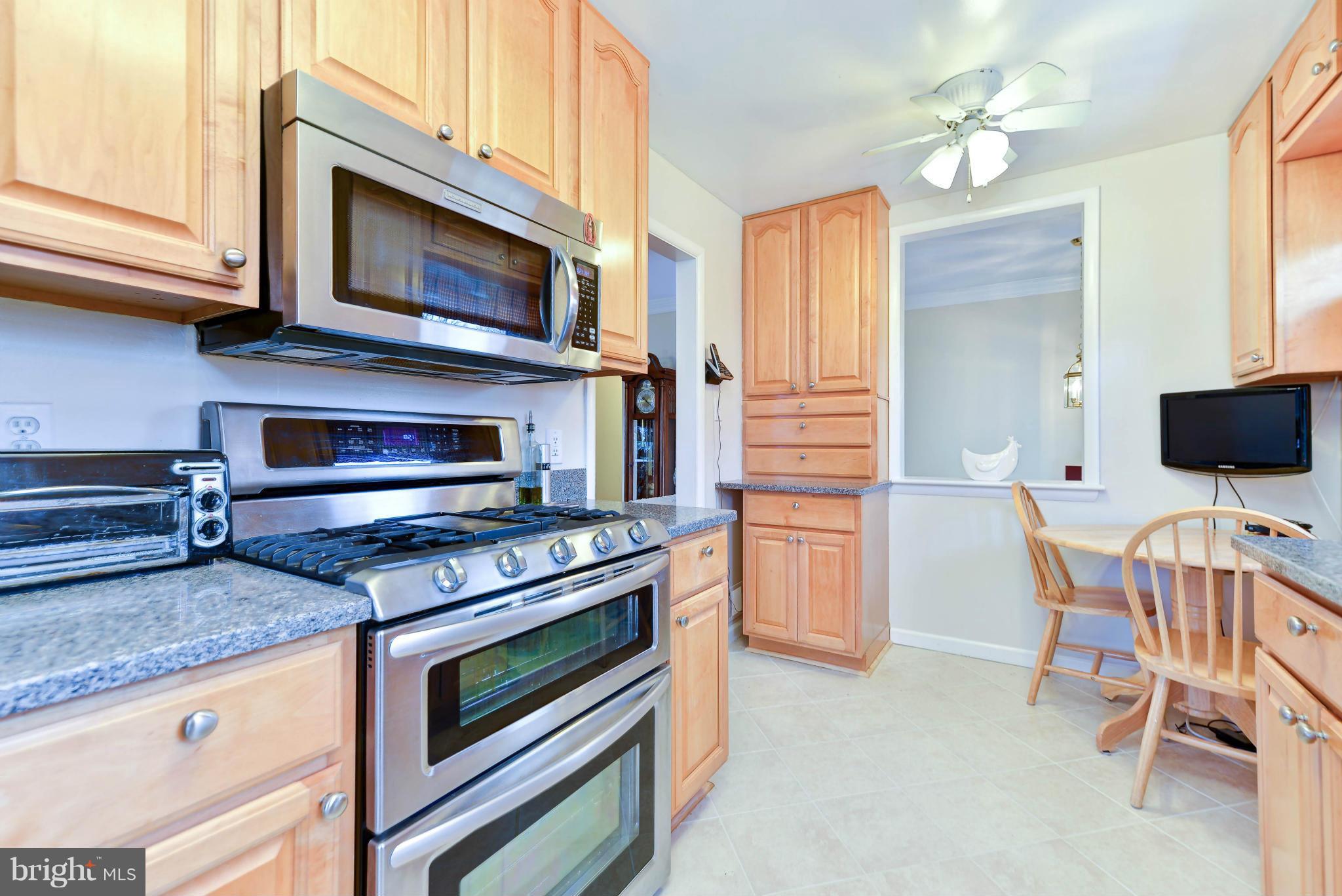 8504 Wagon Wheel Road Alexandria, VA 22309 - Photo 2 of 30 a kitchen with a stove and a microwave