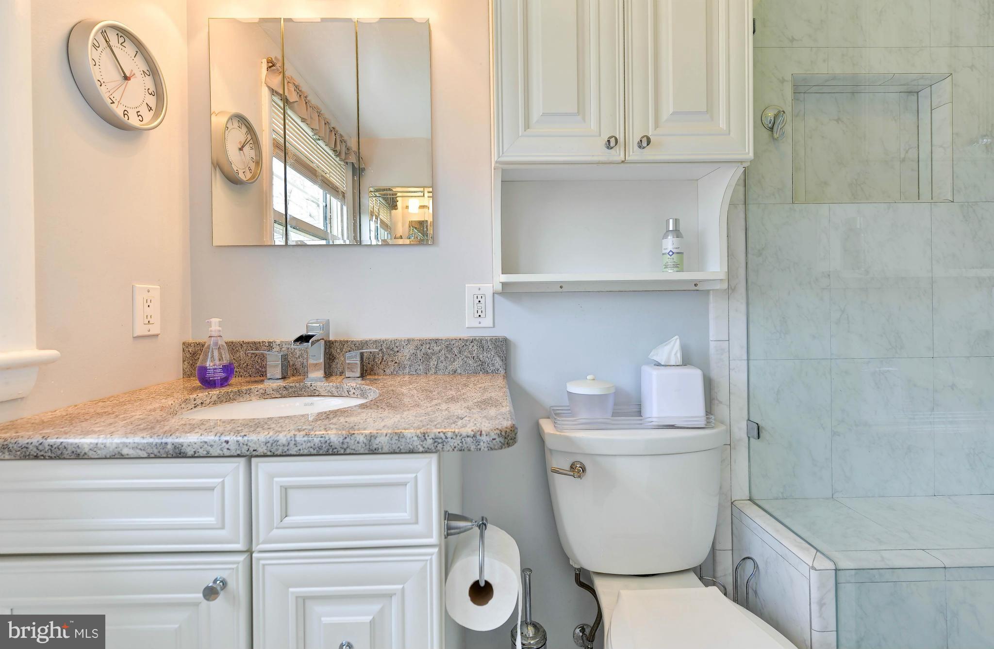 8504 Wagon Wheel Road Alexandria, VA 22309 - Photo 11 of 30 a bathroom with a granite countertop toilet sink and mirror