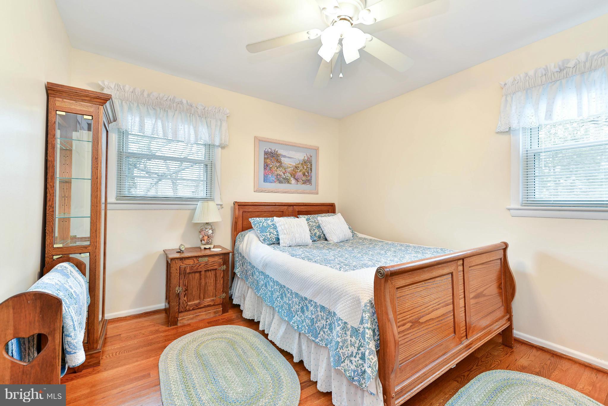 8504 Wagon Wheel Road Alexandria, VA 22309 - Photo 12 of 30 a bedroom with a bed and wooden floor