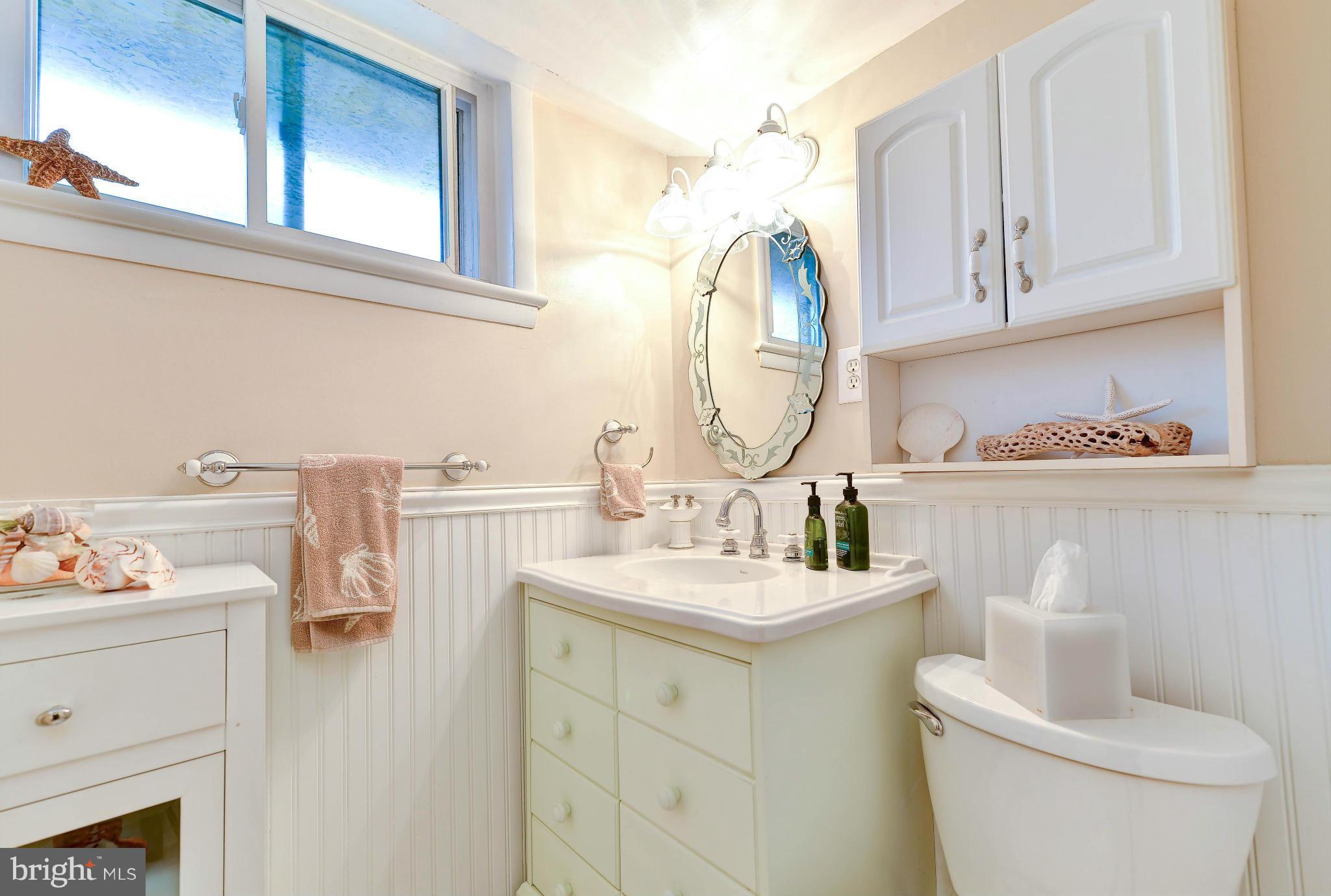 8504 Wagon Wheel Road Alexandria, VA 22309 - Photo 16 of 30 a bathroom with a sink toilet and a mirror