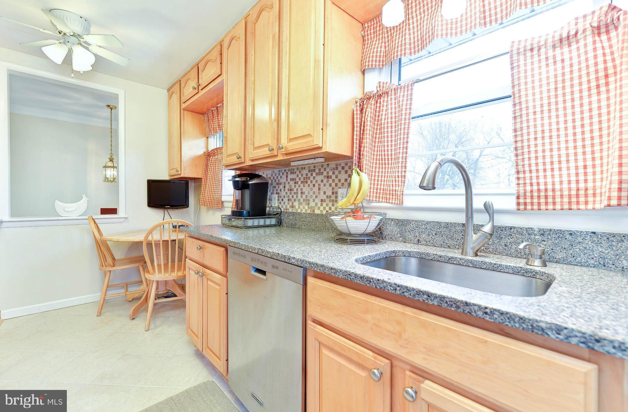 8504 Wagon Wheel Road Alexandria, VA 22309 - Photo 3 of 30 a kitchen with stainless steel appliances granite countertop a sink and a cabinets