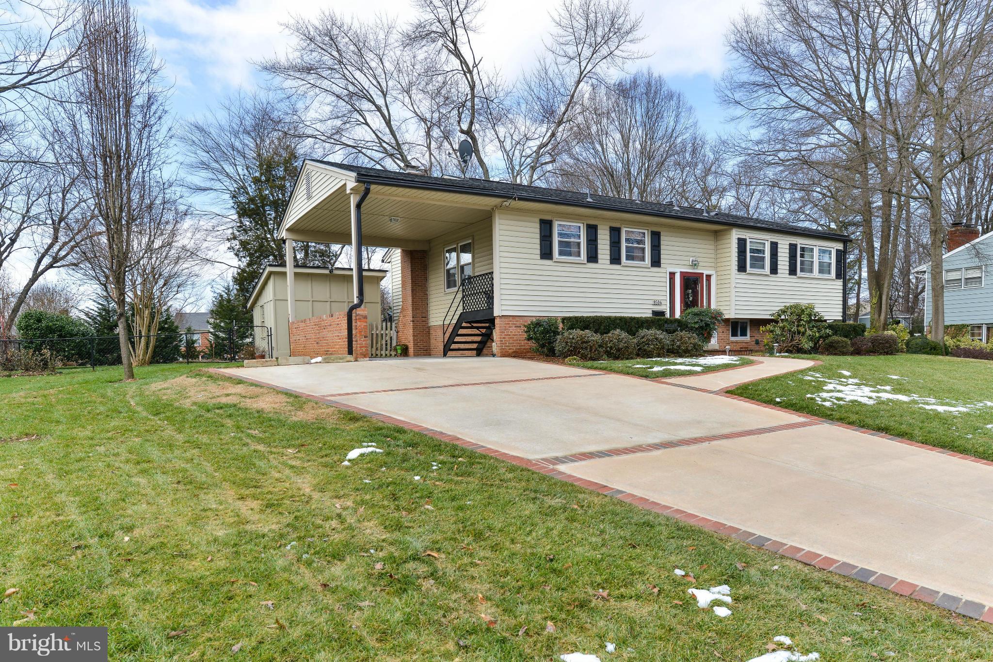 8504 Wagon Wheel Road Alexandria, VA 22309 - Photo 21 of 30 a front view of a house with a yard and trees