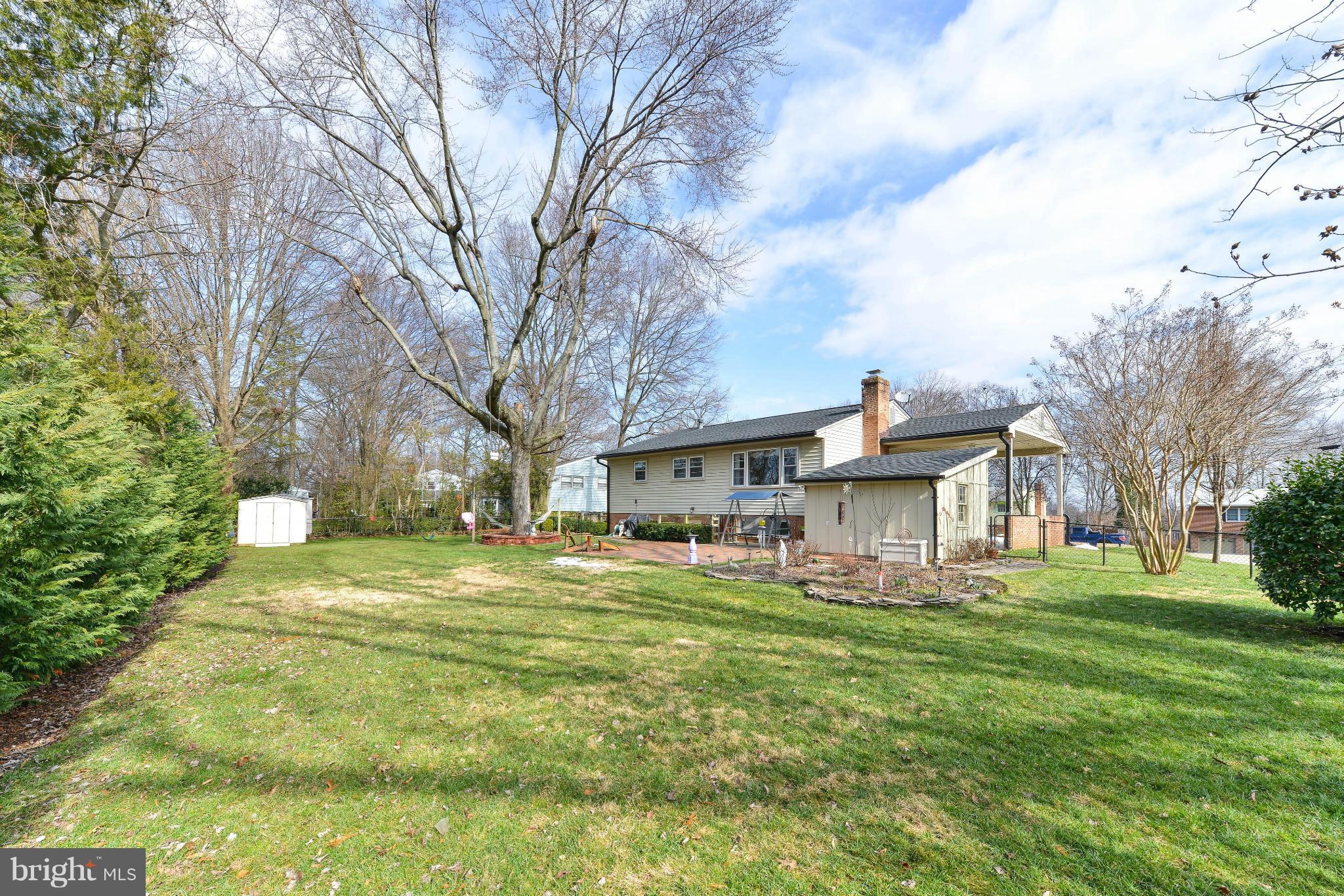 8504 Wagon Wheel Road Alexandria, VA 22309 - Photo 23 of 30 a view of a house with a big yard and large trees
