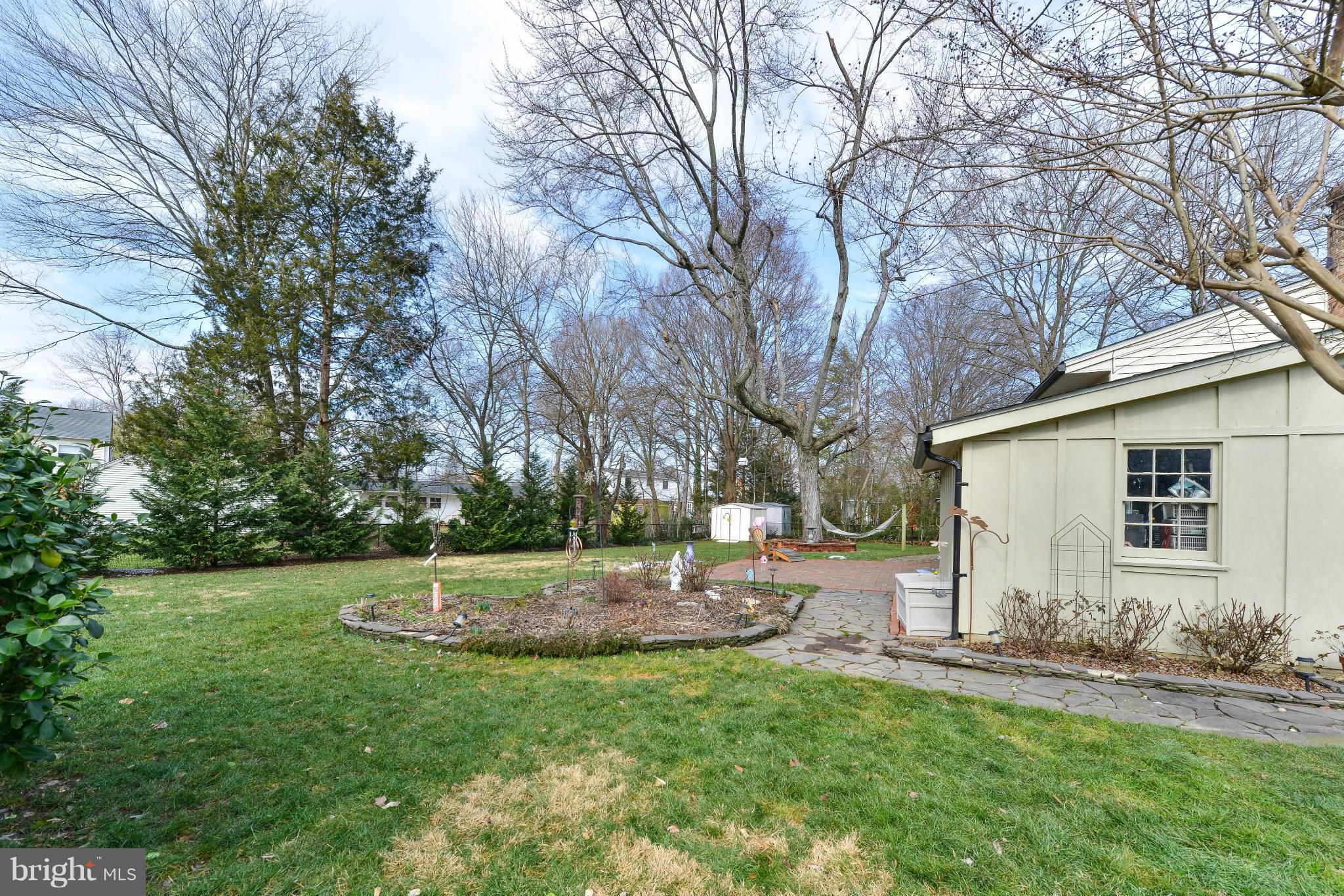 8504 Wagon Wheel Road Alexandria, VA 22309 - Photo 24 of 30 a backyard of a house with plants and large tree