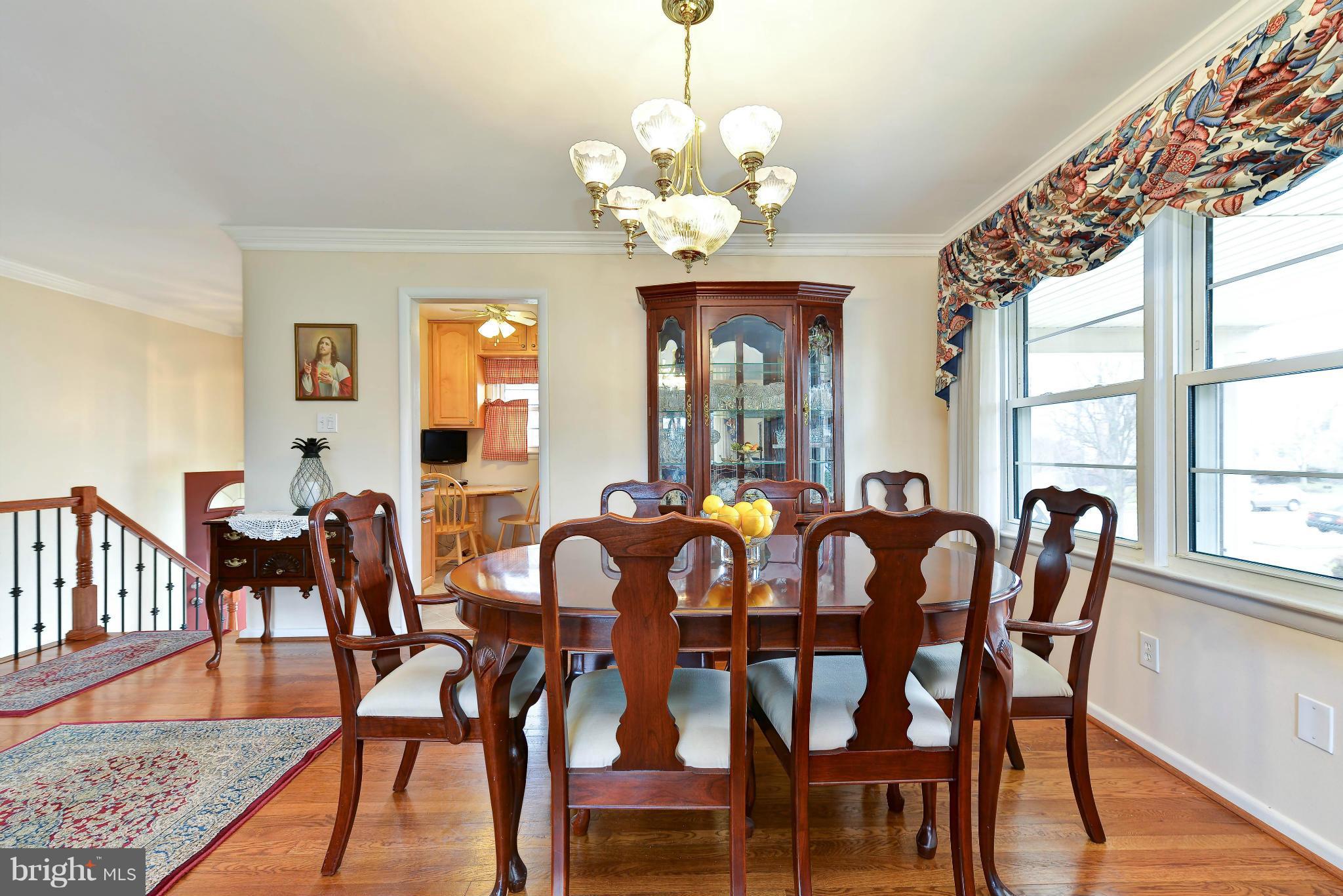 8504 Wagon Wheel Road Alexandria, VA 22309 - Photo 6 of 30 a view of a dining room with furniture a chandelier and wooden floor