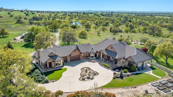 an aerial view of a house with garden space and street view