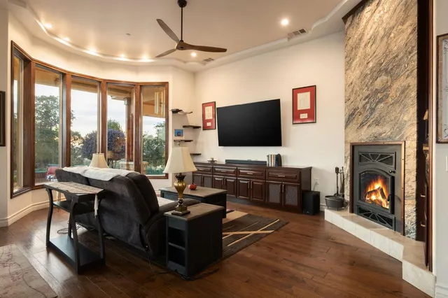 a living room with furniture a flat screen tv and a fireplace