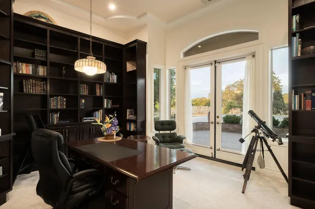 a view of a livingroom with furniture and floor to ceiling window