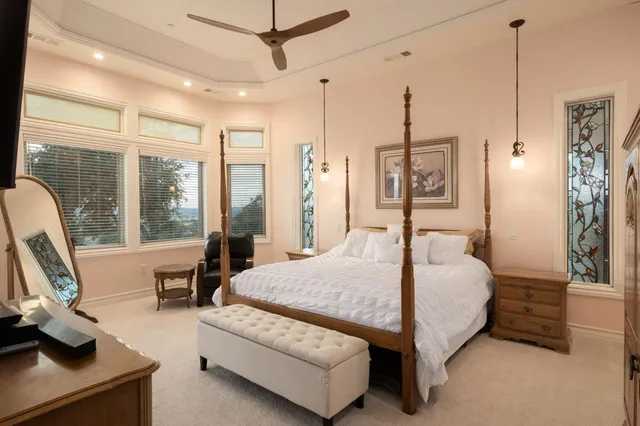 a bed room with a bed window and a chandelier