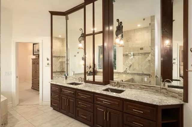 a bathroom with a granite countertop sink mirror and double