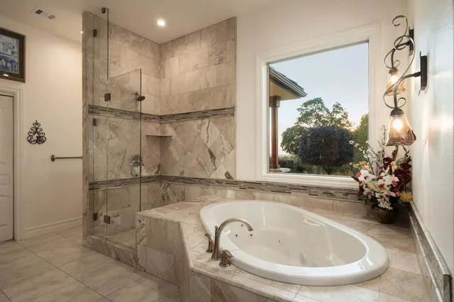 a bathroom with a bathtub and shower