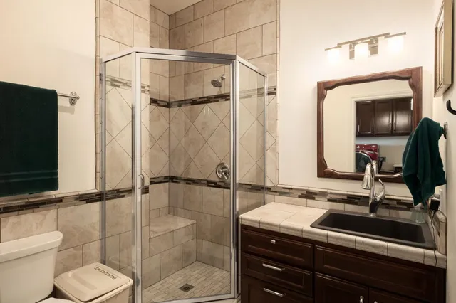 a bathroom with a sink toilet and shower