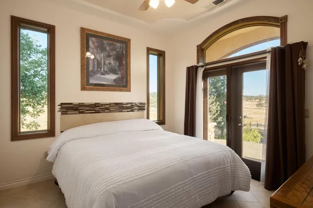 a bedroom with a bed and a painting on the wall