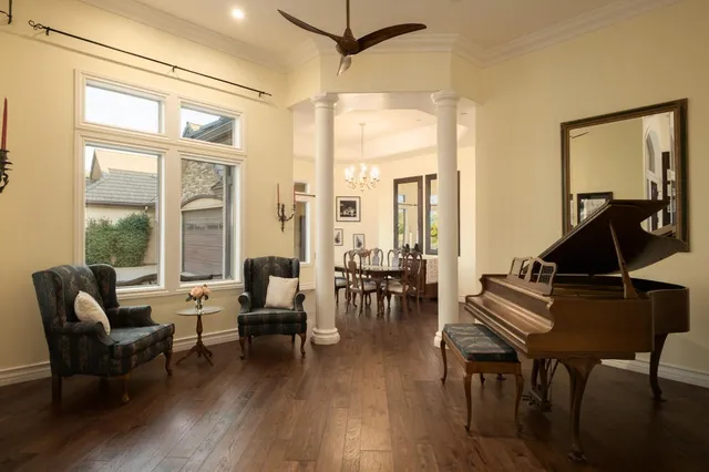 a living room with furniture and wooden floor