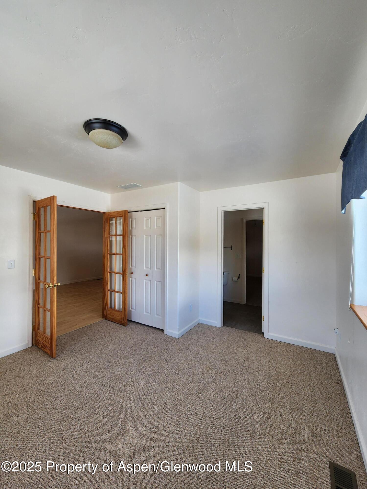 1695 Arabian Avenue Rifle, CO 81650 - Photo 12 of 20 a view of an empty room with closet and a window