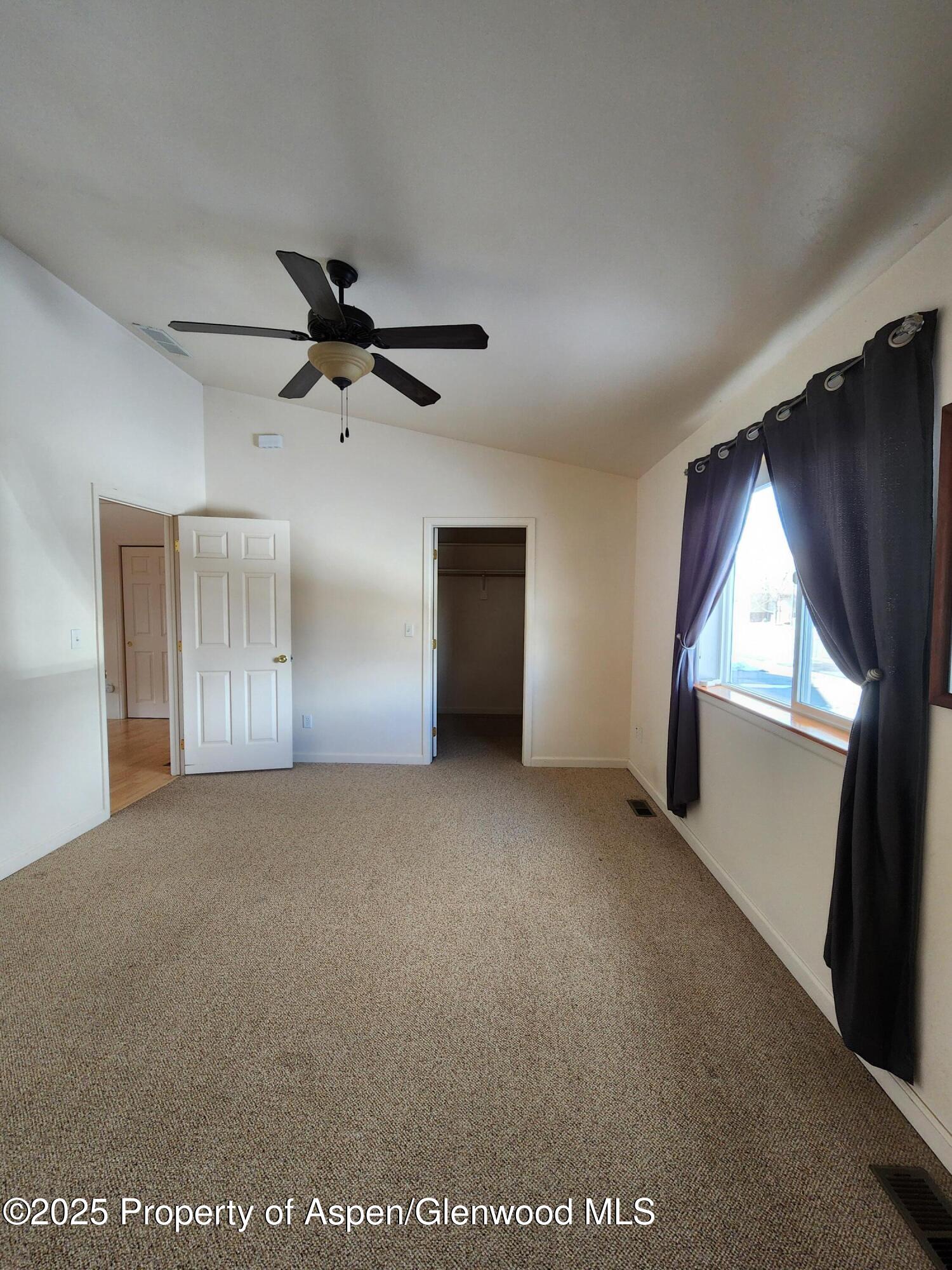 1695 Arabian Avenue Rifle, CO 81650 - Photo 16 of 20 a view of a livingroom with a ceiling fan and window