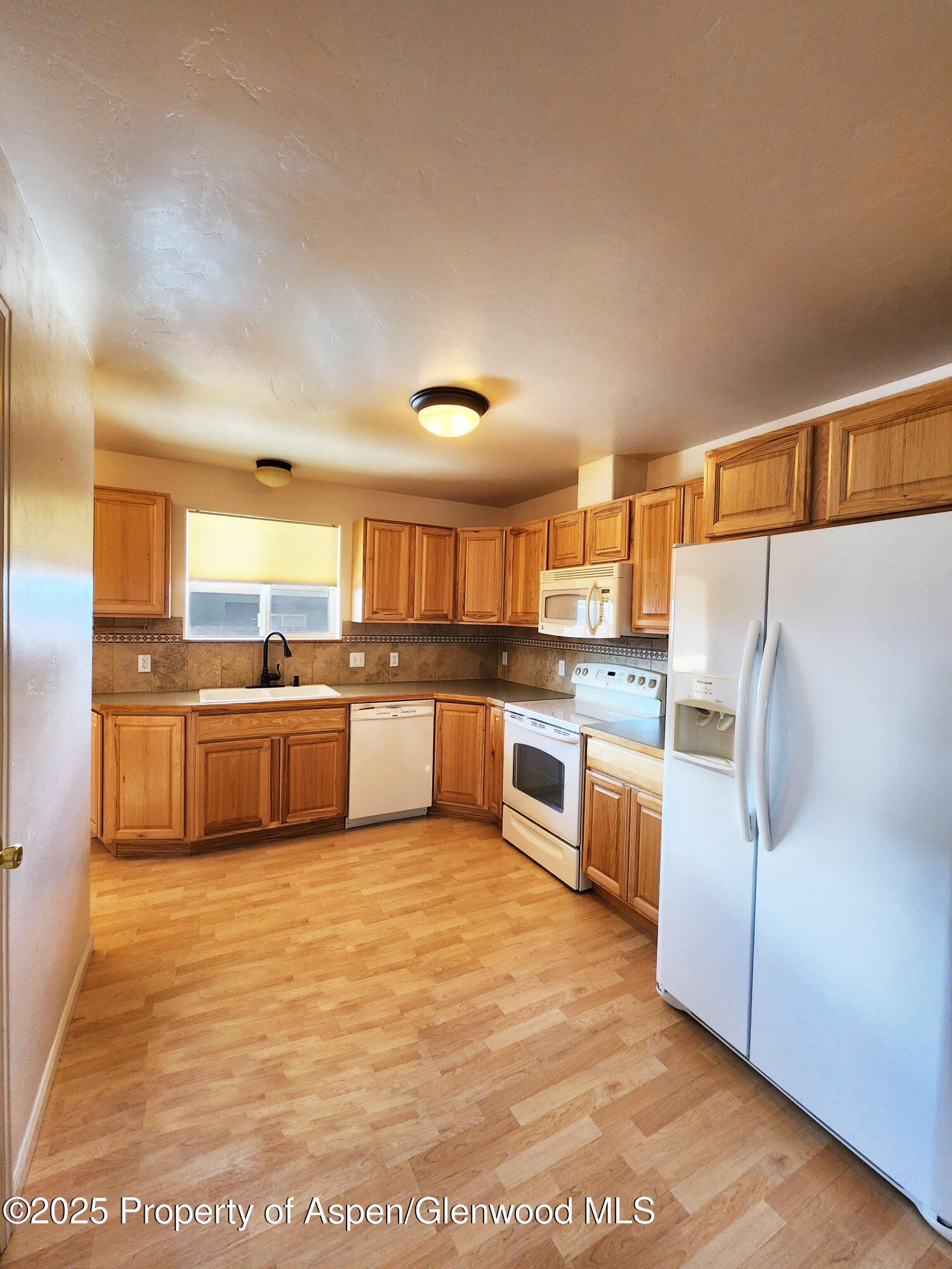 1695 Arabian Avenue Rifle, CO 81650 - Photo 7 of 20 a large kitchen with a cabinets and counter top space