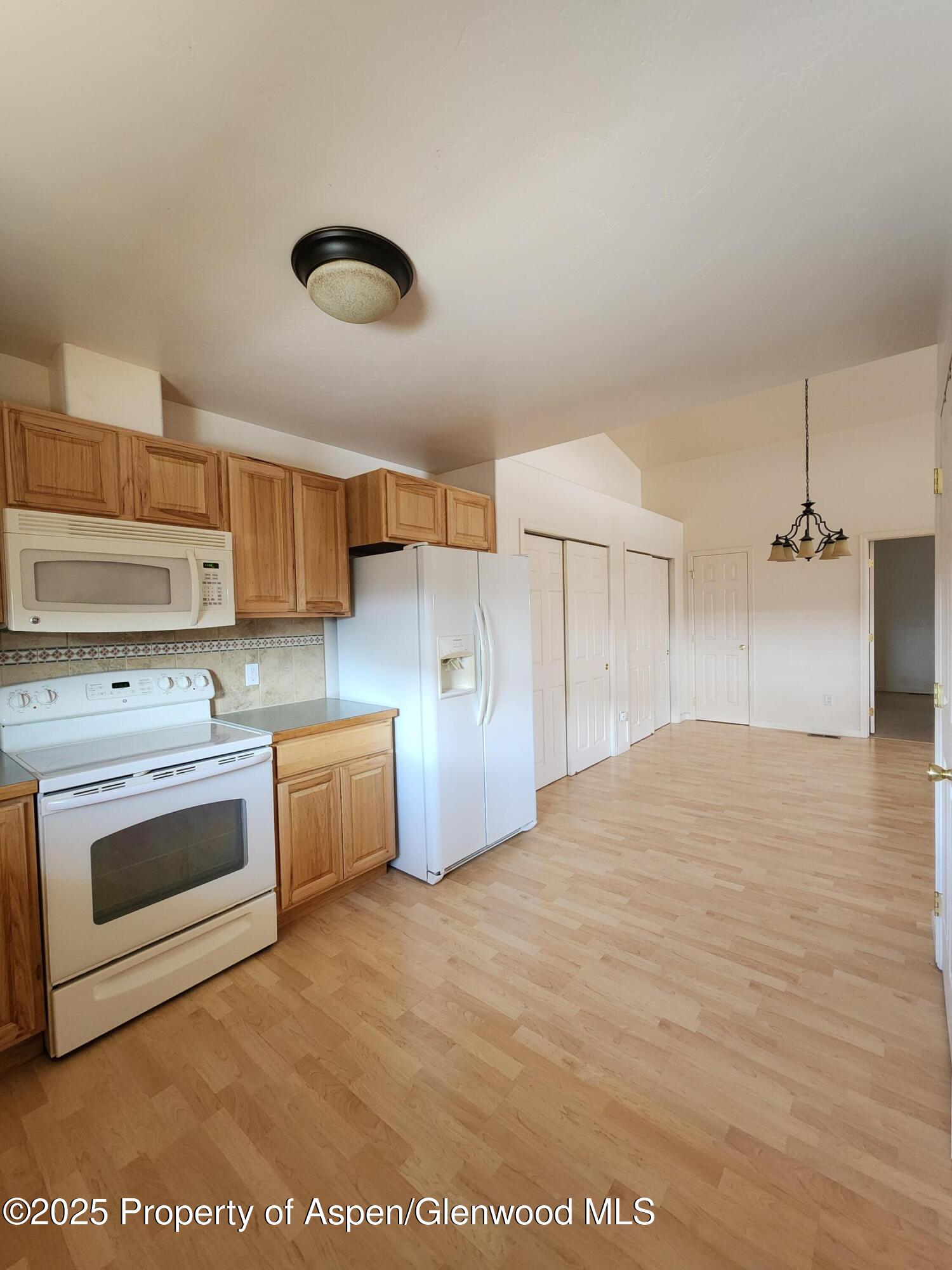 1695 Arabian Avenue Rifle, CO 81650 - Photo 9 of 20 a kitchen with stainless steel appliances granite countertop a stove a sink and a refrigerator