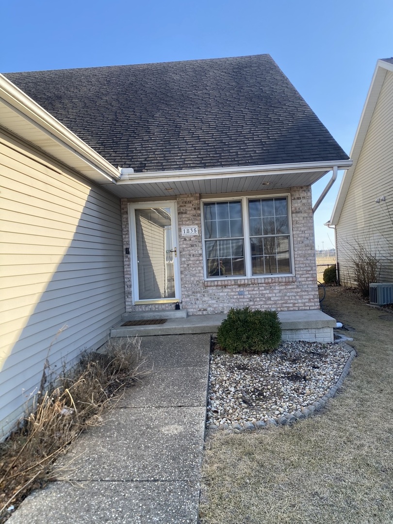 1835 Marina Drive Normal, IL 61761 - Photo 2 of 22 a front view of a house with garden