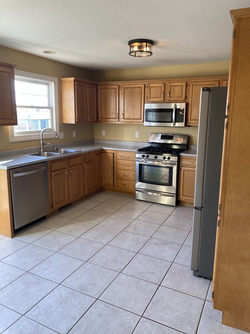 1835 Marina Drive Normal, IL 61761 - Photo 6 of 22 a kitchen with stainless steel appliances granite countertop a refrigerator and a stove top oven