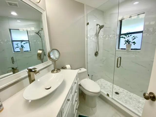 a bathroom with a sink toilet and shower