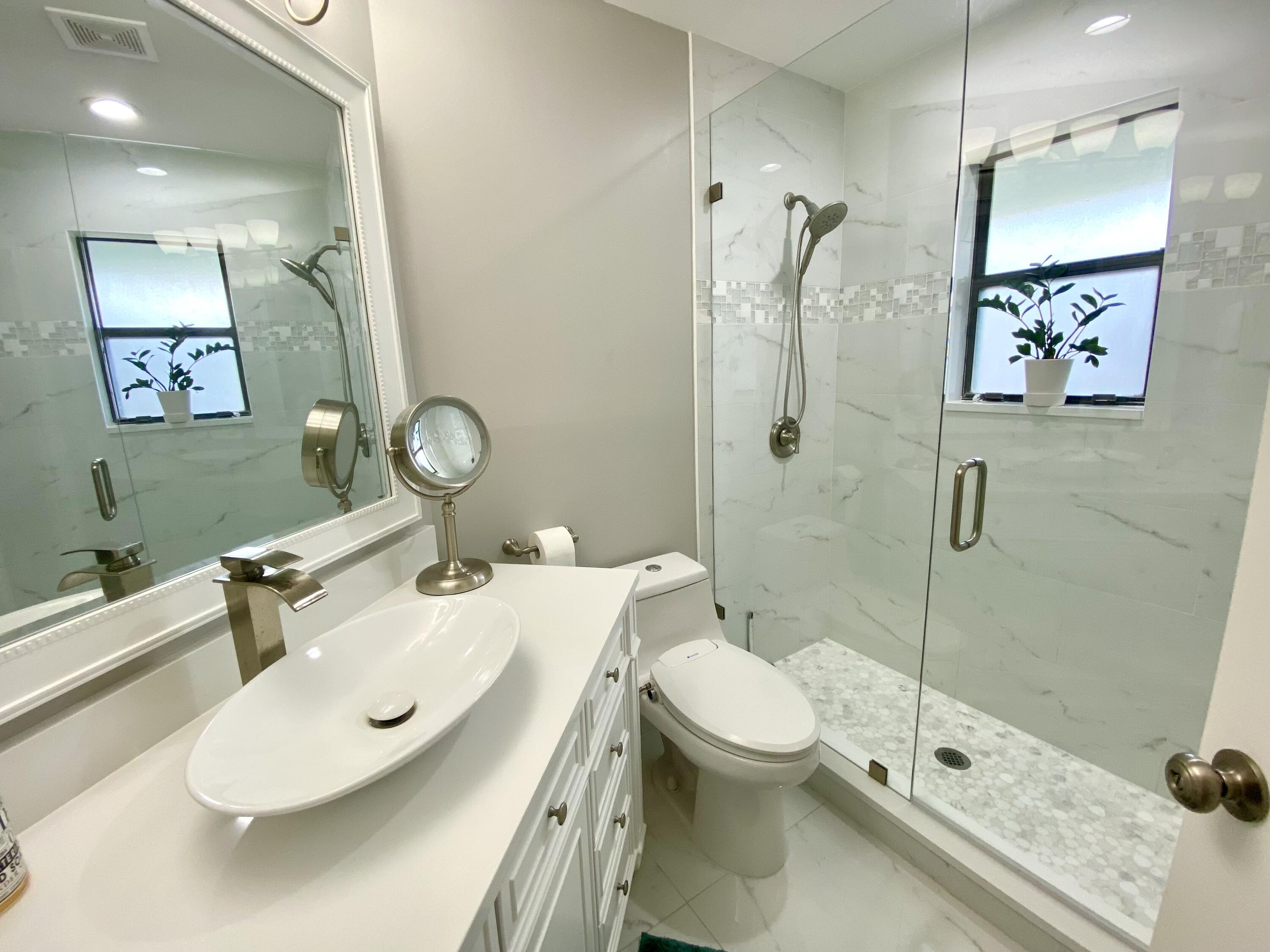 1127 East Seminole Avenue, Unit 13D Jupiter, FL 33477 - Photo 13 of 20 a bathroom with a sink toilet and shower
