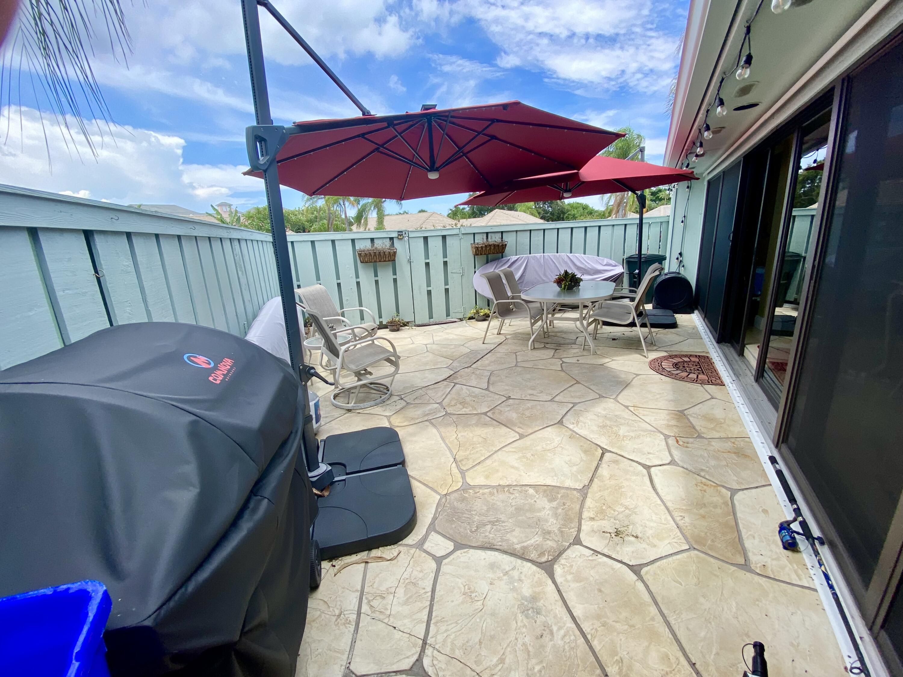 1127 East Seminole Avenue, Unit 13D Jupiter, FL 33477 - Photo 15 of 20 a view of outdoor kitchen with seating area